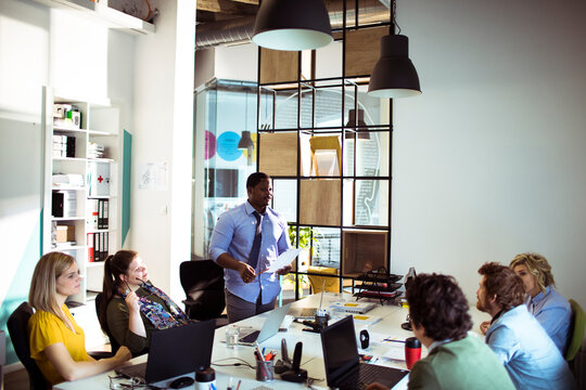 Man presenting to team in modern office