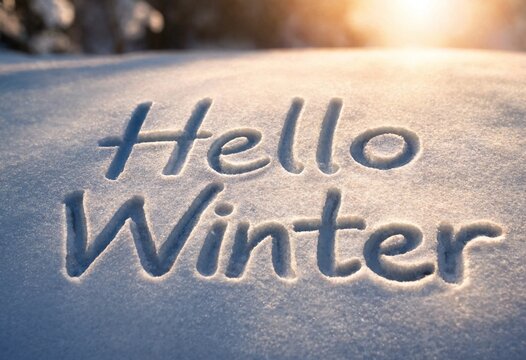 Hello Winter written in freshly fallen snow on a sunny winter day background
