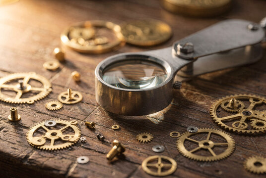Close-up of Vintage Watch Gears and Magnifying Glass on Wooden Table