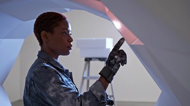 Woman with prosthetic hand touches holographic display in futuristic space. Female cyborg uses prosthetic arm with digital interface. Woman interacts with holographic technology using bionic hand.