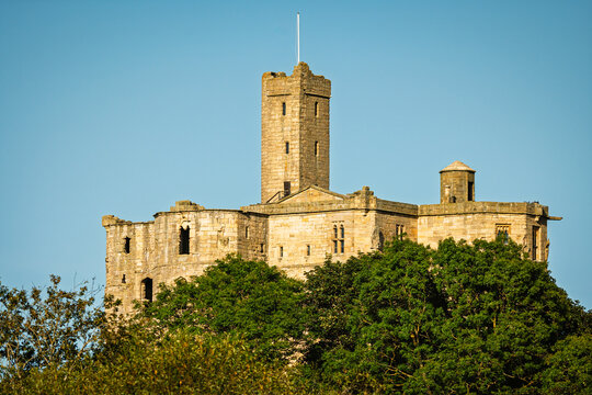 Warkworth Castle as seen from the Riverside Walk, a pleasant easy riverside walk along the River Coquet at Warkworth in Northumberland with lots of interest and wildlife to be seen