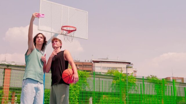 Multicultural friends taking a selfie on a basketball court