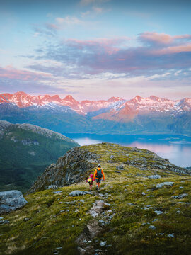Family father and child hiking together active travel in Norway, parent and kid on camping vacations tour in Meloy outdoor summer holidays people enjoying midnight sun season in mountains eco tourism
