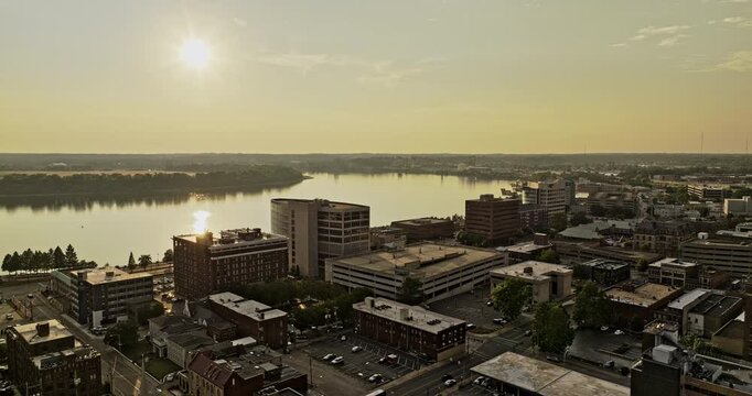 Evansville Indiana Aerial v9 cinematic drone flyover town center capturing beautiful sunset glow casting over the downtown cityscape and river landscape - Shot with Mavic 3 Pro Cine - September 2023