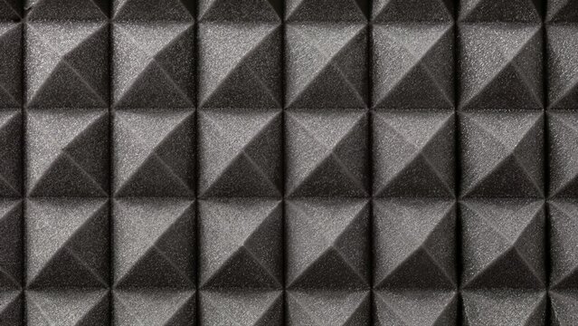 Dark gray acoustic foam pyramid panel texture. Soundproofing studio wall treatment for audio recording
