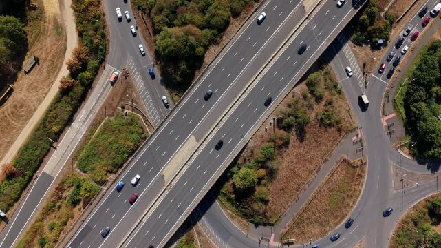 Top down aerial hyperlapse of busy traffic moving along the A1 motorway junction in the UK