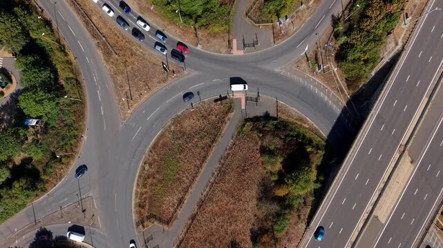 Top down aerial hyperlapse of busy traffic moving along the A1 motorway junction in the UK