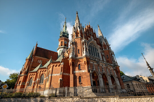 Krakow, Poland - July 18, 2026: Low-angle side view of the red-brick Neo-Gothic St. Joseph&rsquo;s Church in Podgorze.