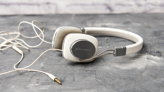 Bowers & Wilkins P3 wired headphones rest beside their cable and audio plug.