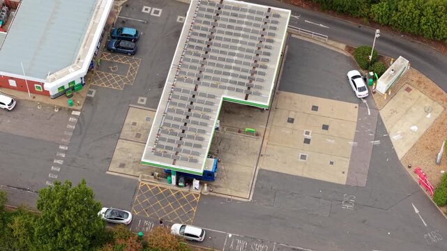 Aerial view of busy petrol station forecourt with queuing traffic waiting for fuel in Bedford, UK