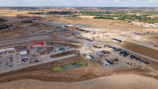 Aerial view of major highway construction site with new bridge structures and earthworks in Bedfordshire, UK