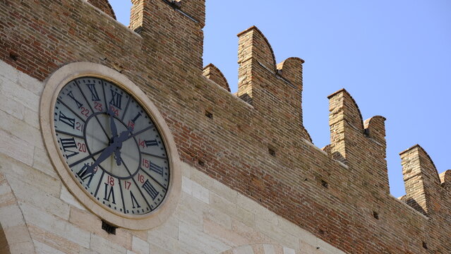 Medieval crenellated city walls and historic clock at Piazza Bra, Verona