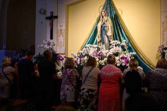 Pilgrims praying at the statue of the Virgin Mary in the St James church in Medjugorje, Bosnia and Herzegovina.