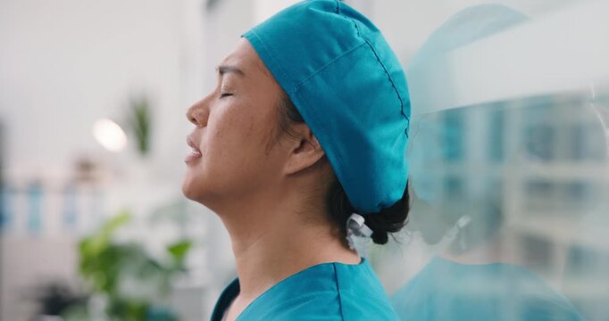 Frustrated, woman or nurse with stress on glass window for medical failure, mistake or bad procedure. Upset, female person or health surgeon with reflection for surgical crisis or loss in hospital