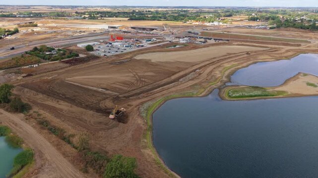 Aerial view of heavy plant machinery conducting extensive earthworks at a highway junction in Bedfordshire, UK