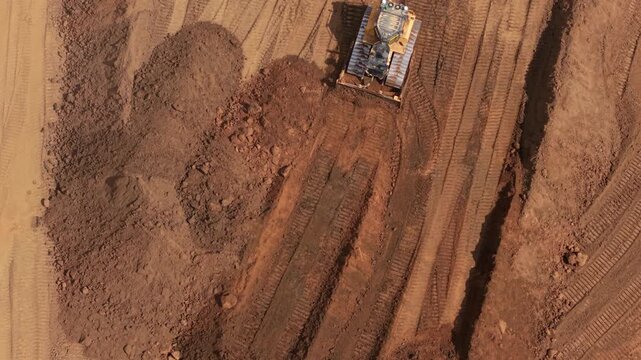 Aerial view of heavy earthmoving machinery moving soil spoil during major highway construction in Bedfordshire, UK