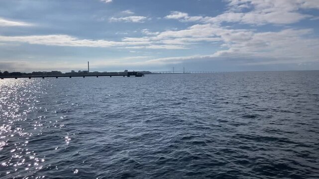 View towards the Oresund Bridge from a pier at Ribersborg beach in Malmo