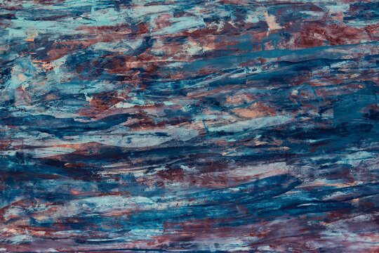 Deep blue and rust hues swirl across the surface. Textures ripple like liquid stone or weathered metal. Colors blend in organic, flowing motion. Suitable for abstract backgrounds or design overlays