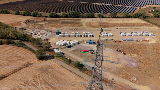Aerial view of co-located photovoltaic solar farm array and battery energy storage system in Eaton Socon, UK