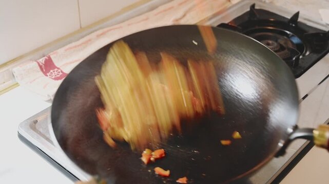 Stir Frying Tomatoes with Scrambled Eggs in an Iron Wok