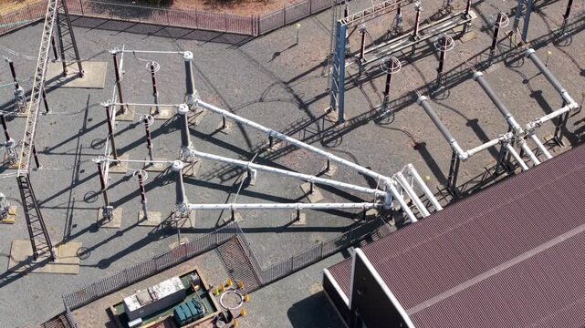 Close-up aerial view of high voltage step-down transformers and electrical switchgear in Eaton Socon, UK