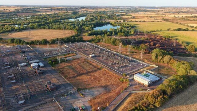 Aerial view of massive 400kV electrical substation with busbars, transformers, and transmission switchgear in Grendon, UK