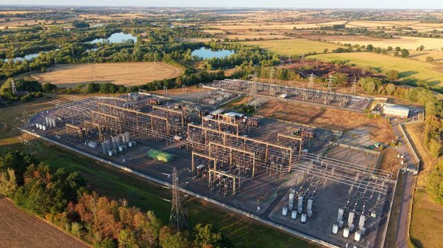 Aerial view of massive 400kV electrical substation with busbars, transformers, and transmission switchgear in Grendon, UK