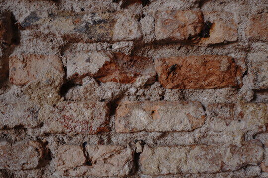 Weathered brick wall with rough mortar showing texture and age