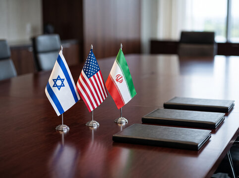 small flags of israel usa and iran on table in conference room near document folders symbolism of diplomatic negotiations and international relations during meeting