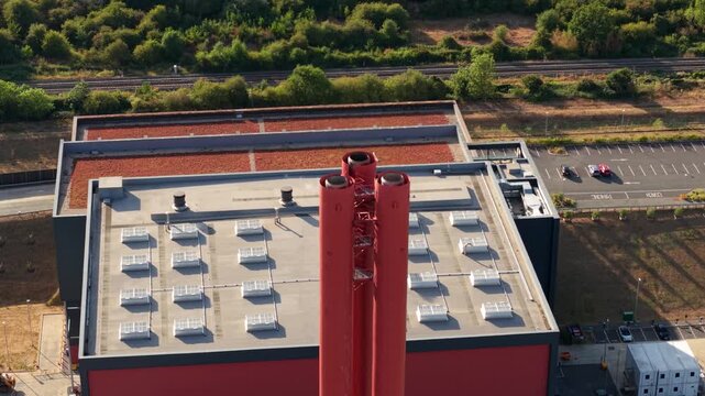 Close-up aerial view of industrial power station exhaust stacks and rooftop ventilation systems in Bedford, UK