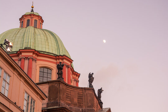Green dome and statues of the Church of Saint Francis of Assisi in Krizovnicke Square, Prague, Czech Republic.