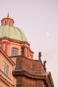 Green dome and statues of the Church of Saint Francis of Assisi in Krizovnicke Square, Prague, Czech Republic.