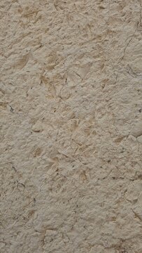 Weathered rough stucco wall texture background of an old vintage building