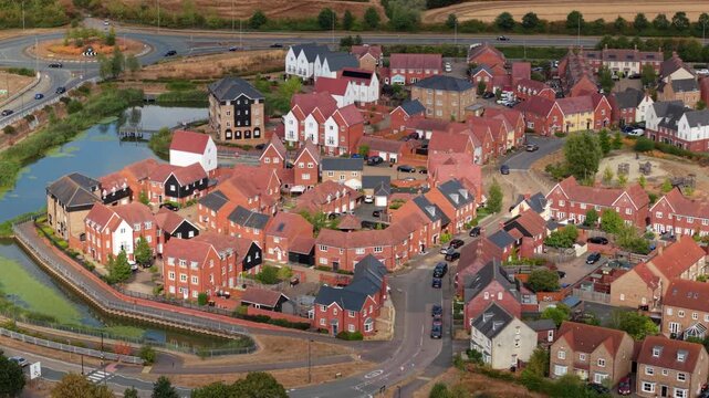 Aerial view of modern residential housing estate and suburban road network in Bedford, UK