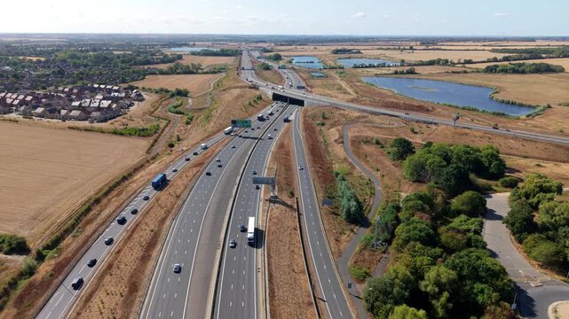 Aerial view of multilane traffic travelling along a major motorway highway in England, UK