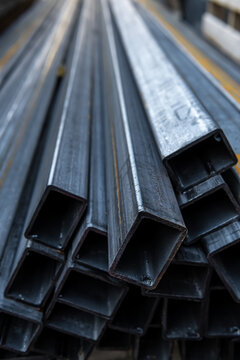 Stacked rusty square steel metal tubes