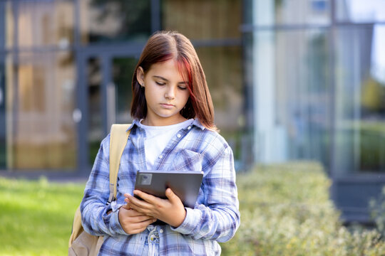 Teen girl using digital tablet for modern education
