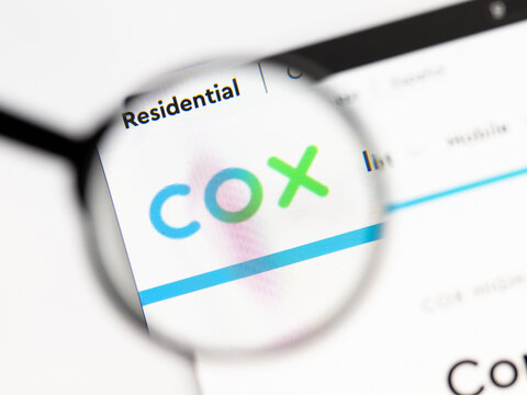 Milan, Italy 2026, 15 AGO Closeup of cox net website page on a laptop screen. Focus on cox net logo under a magnifying glass.