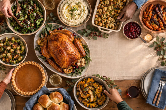 Hands Sharing Thanksgiving Potluck Feast from Above for Holiday Dining and Hospitality Campaigns