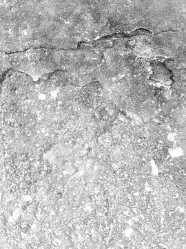 Distressed White Concrete Wall Texture with Black Grunge Marks, Cracked Paint, Rough Surface and Vintage Weathered Effect. Vintage Distressed Concrete Texture with White Paint, Dark Scratches.