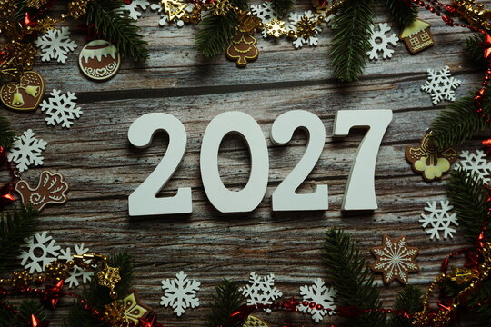 2027 Happy New Year and Christmas decoration on wooden background