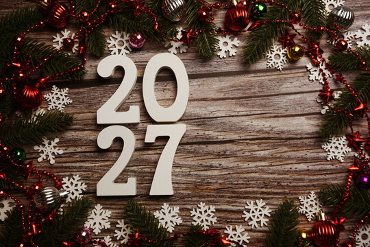 2027 Happy New Year and Christmas decoration on wooden background