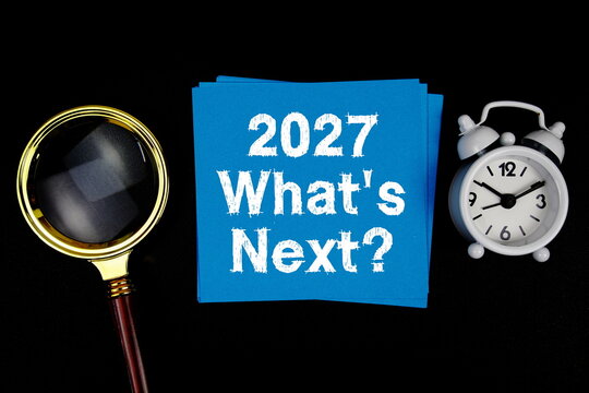 2027 What's Next? text with magnifying glass and alarm clock on black background
