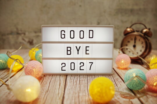 Goodbye 2027 text on lightbox on wooden background