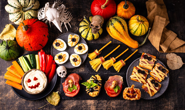Halloween appetizers with pumpkin hummus deviled eggs and mummy snacks