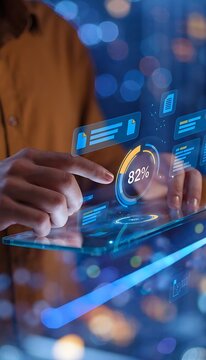 Female professional in mustard long-sleeve shirt interacting with digital data visualization on transparent tablet in modern office environment