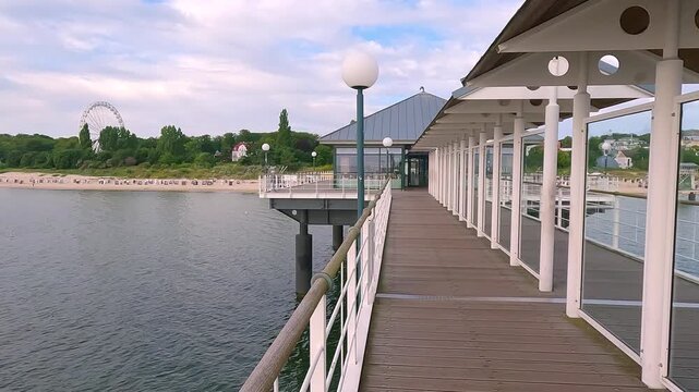 Mettal boat ramp on empty beach. Picturesque summer sunrise on popular tourist attraction - Heringsdorf Pier with a lots of Shopping mail, Germany, Europe. 4K video (Ultra High Definition).