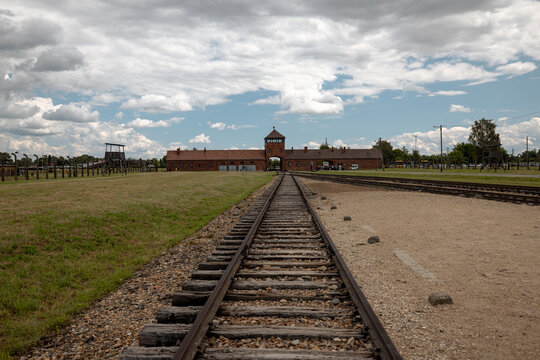 Oświęcim, Poland - July 20, 2026: Preserved railway tracks lead toward the Gate of Death at the former Auschwitz II-Birkenau Nazi concentration and extermination camp.