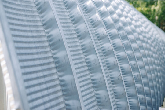 close-up of a frameless metal hangar with repeating arched panels.construction concept