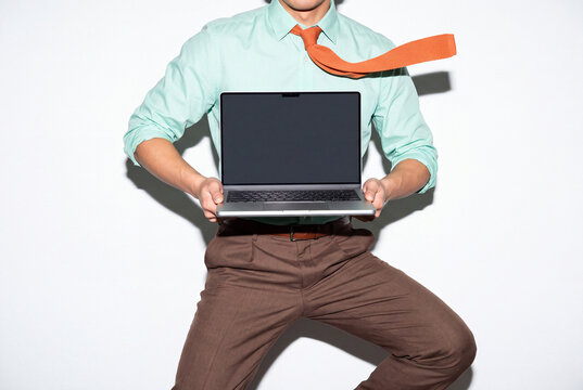 Energetic Businessman Leaping With Laptop